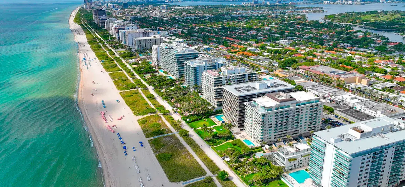 Surfside coastline with beach, park and condominiums seen from above