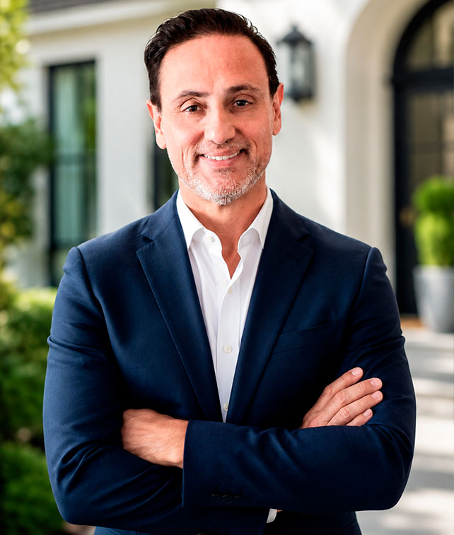 Alejandro Bernal – Florida Real Estate Expert Alejandro Bernal, professional Full-Stack Realtor and Airbnb Super Host standing in front of Miami luxury buildings in Florida.