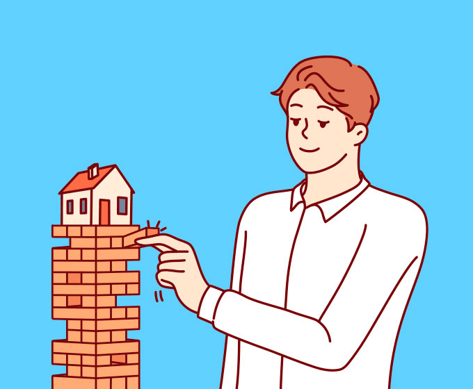 Man balancing a house model on a wooden blocks tower for real estate guidance by Alejandro Bernal